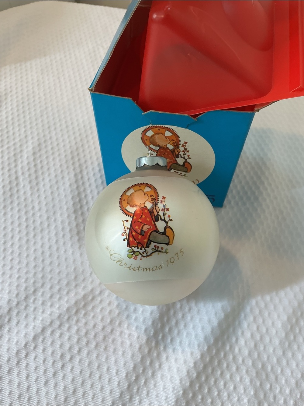 Vintage-style White Christmas Ornament with Angel Illustration